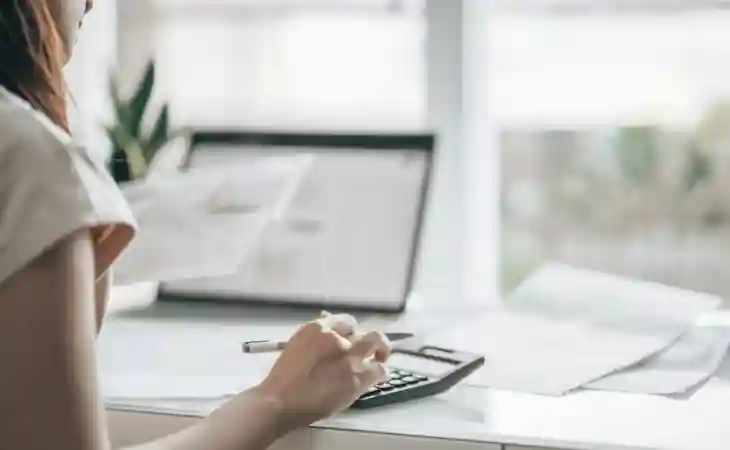 Woman sitting at a home desk doing finances.