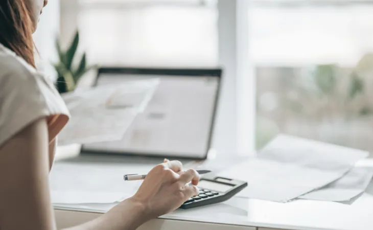 Woman sitting at a home desk doing finances.