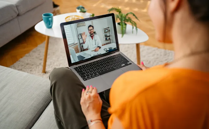 A woman having a virtual appointment with her physician on her laptop. 